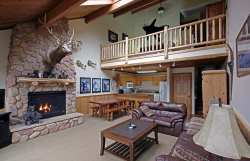 Image of Looking for the perfect getaway? This two bedroom cabin in the woods has a master bedroom with a king sized bed and a loft area with a queen sized bed. There is also a sleeper sofa in the living area.The cottage offers a full kitchen, is fully furnished, and includes a stone fireplace. 