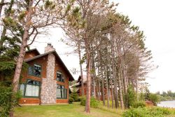 Image of This two bedroom cottage has a master bedroom with a king sized bed and a loft area with a queen sized bed. There is also a sleeper sofa in the living area. There is a full kitchen and is fully furnished throughout. The deck offers a grill and breathtaking views of the lake.